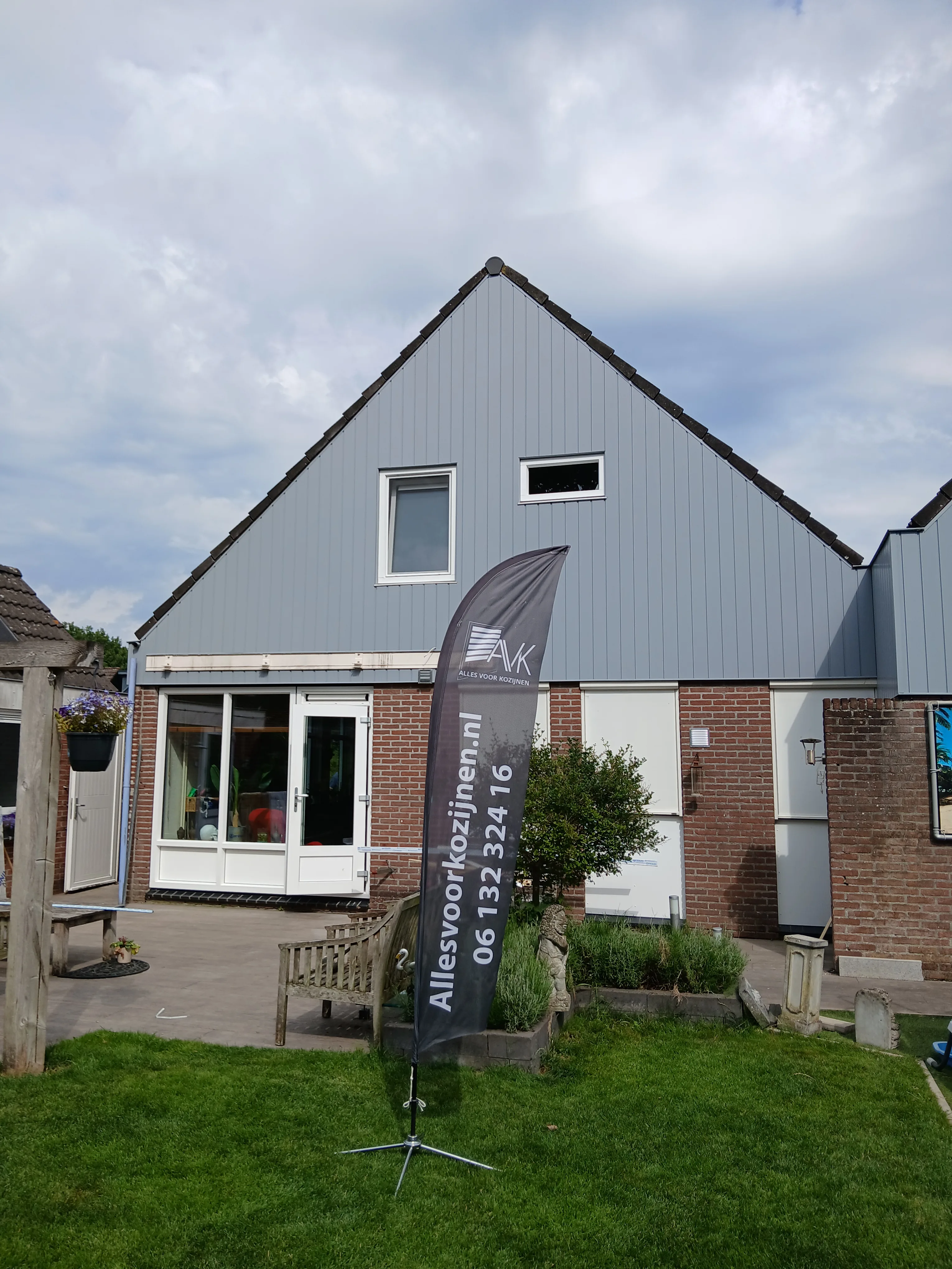 Voorbeeld van een woning met kunststof gevelbekleding en kozijnen